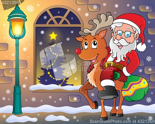 Image of Santa Claus on reindeer in town