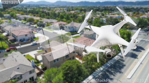 Image of Unmanned Aircraft System (UAV) Quadcopter Drone In The Air Over 