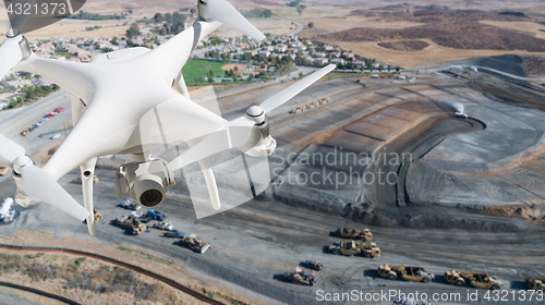 Image of Unmanned Aircraft System (UAV) Quadcopter Drone In The Air Over 