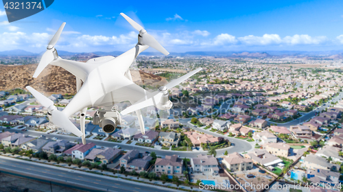 Image of Unmanned Aircraft System (UAV) Quadcopter Drone In The Air Over 