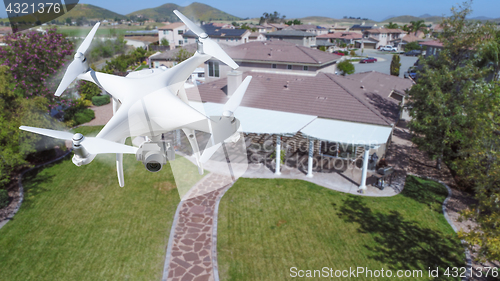 Image of Unmanned Aircraft System (UAV) Quadcopter Drone In The Air Over 