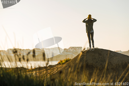 Image of Woman over the cliff