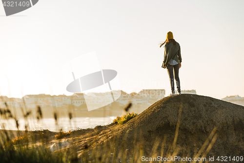 Image of Woman over the cliff