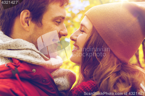 Image of close up of happy young couple kissing outdoors