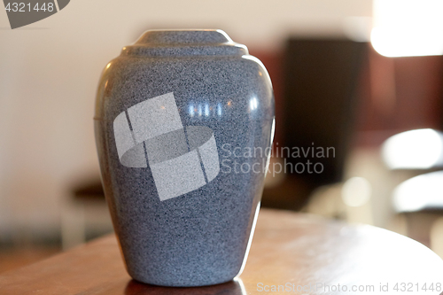 Image of cremation urn on table in church