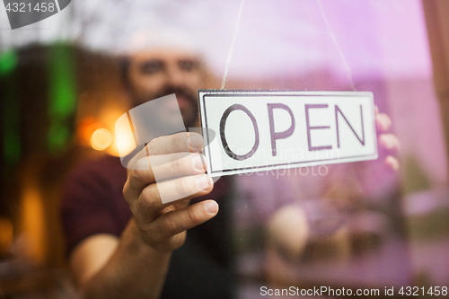 Image of man with open banner at bar or restaurant window