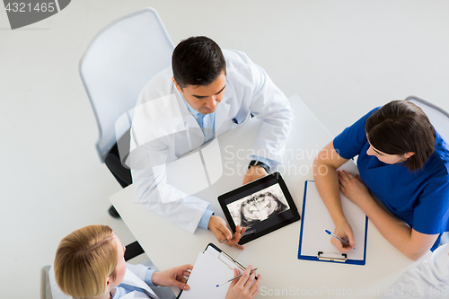 Image of doctors with jaw x-ray on tablet pc at clinic