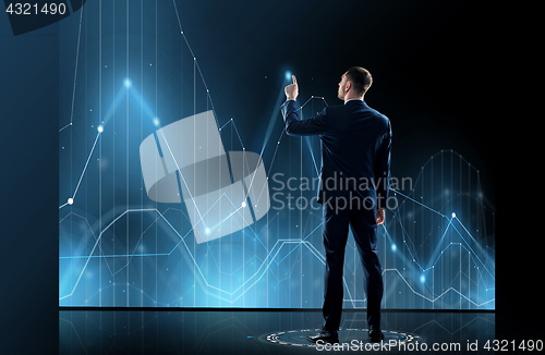 Image of businessman in suit touching virtual graph