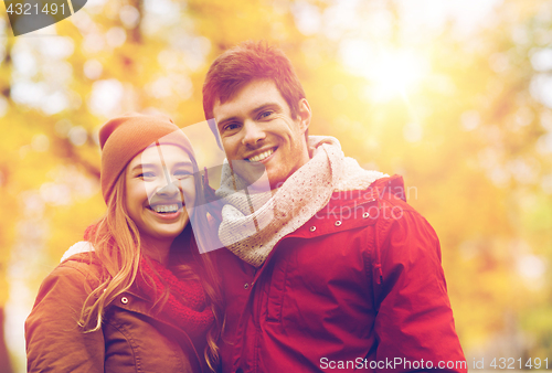 Image of happy young couple walking in autumn park