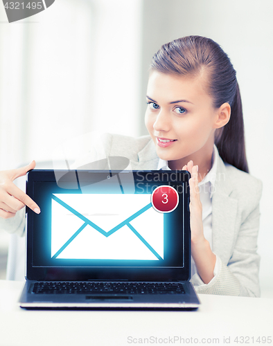 Image of businesswoman with laptop in office