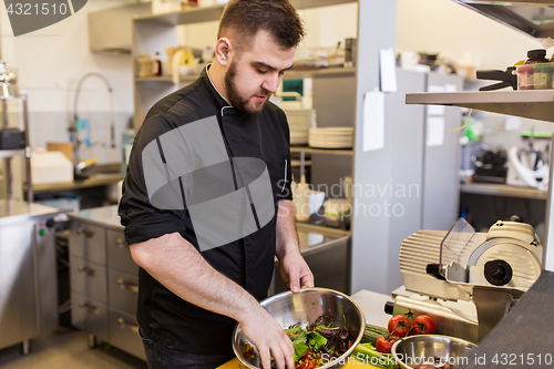 Image of chef cook making food at restaurant kitchen