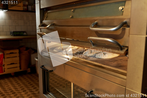 Image of yeast bread dough in oven at bakery kitchen