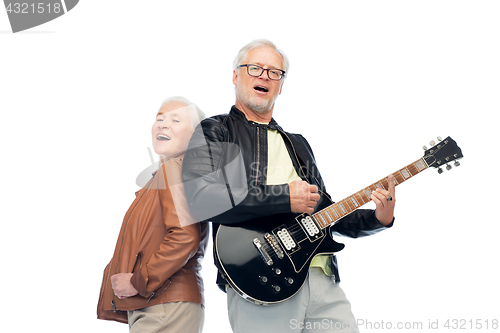 Image of happy senior couple with electric guitar singing