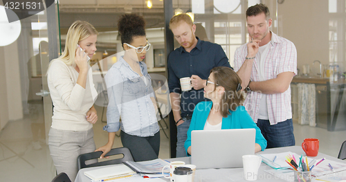 Image of Coworkers watching laptop