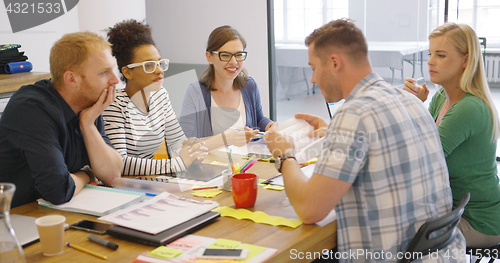 Image of Coworkers at table with documents