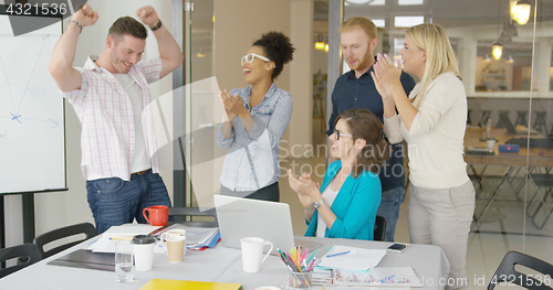 Image of Cheerful coworkers celebrating