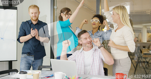 Image of Coworkers celebrating victory in office