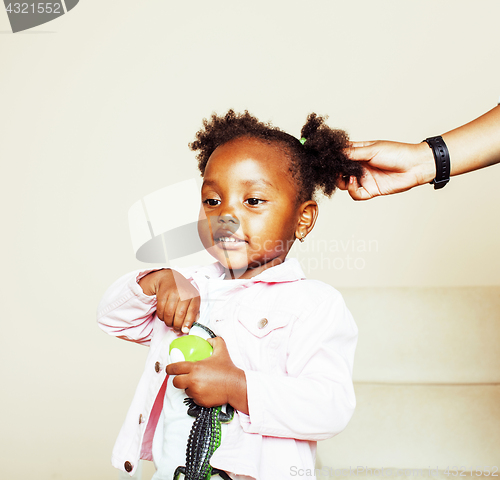 Image of little cute sweet african-american girl playing happy with toys 