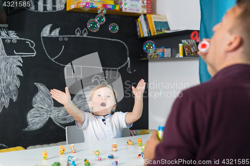 Image of Cute little toddler boy at speechtherapist session.