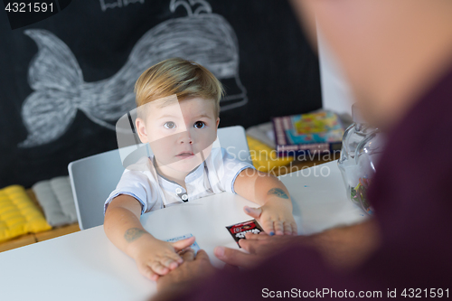 Image of Cute little toddler boy at speechtherapist session.