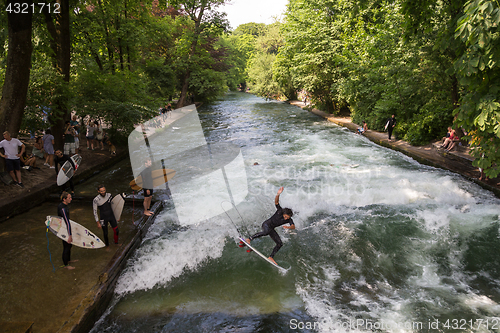 Image of Surfer surfing an artificial wave in Munich city center, Germany.