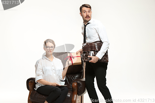 Image of The young man and beautiful woman in business suit at office on white background