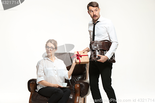 Image of The young man and beautiful woman in business suit at office on white background