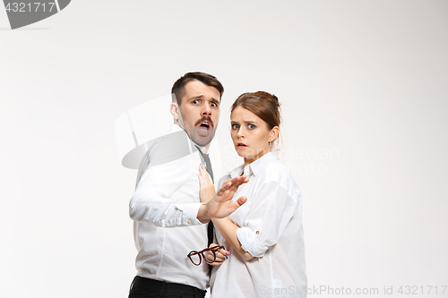 Image of Successful business couple at the office looking at camera