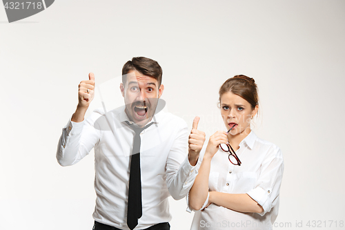 Image of Successful business couple at the office looking at camera