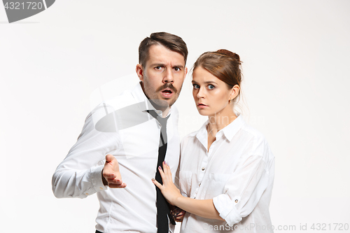 Image of Successful business couple at the office looking at camera