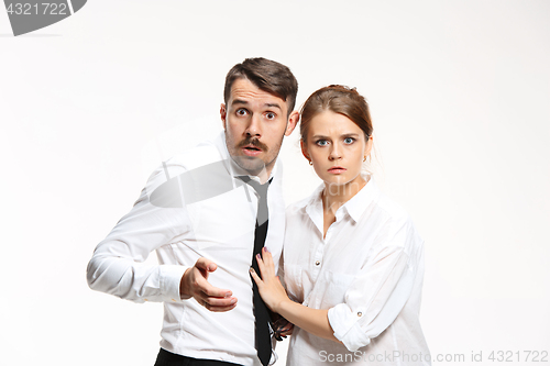 Image of Successful business couple at the office looking at camera