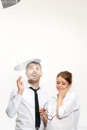 Image of Successful business couple at the office looking up