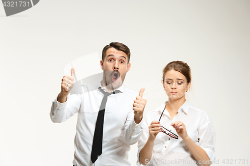 Image of Successful business couple at the office looking at camera