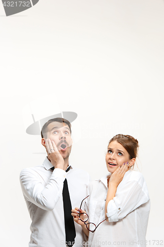 Image of Successful business couple at the office looking up
