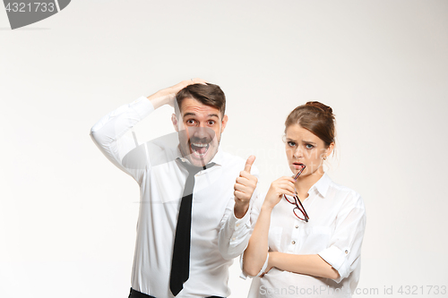 Image of Successful business couple at the office looking at camera
