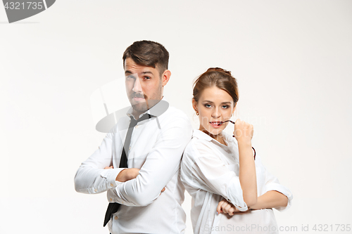 Image of Successful business couple at the office looking at camera