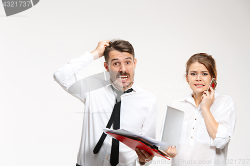 Image of The troubled business couple at the office looking at camera