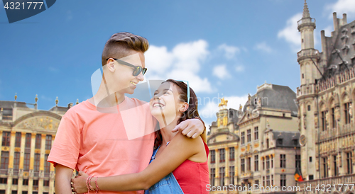 Image of happy teenage couple hugging in brussels city