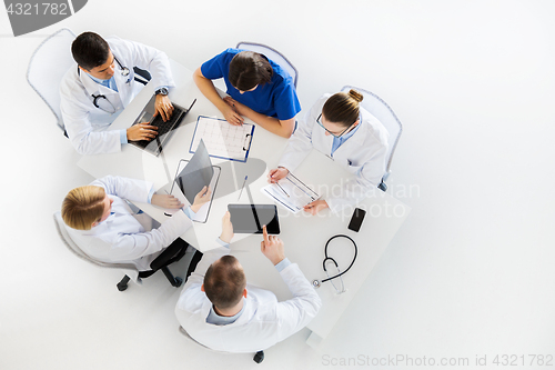 Image of doctors with x-ray and cardiogram at hospital