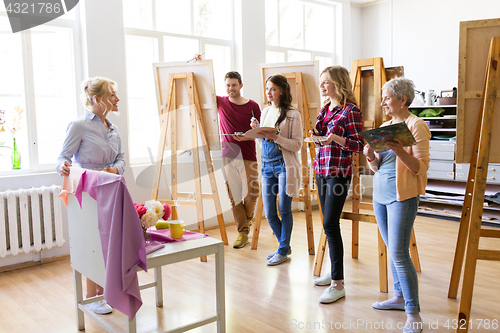 Image of students and teacher with still life at art school