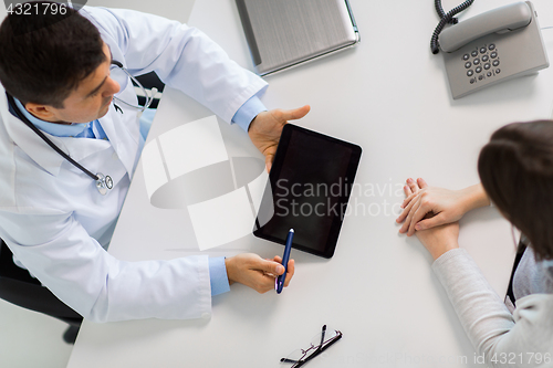 Image of smiling doctor and young woman meeting at hospital