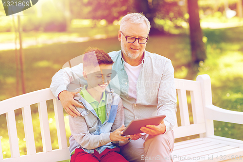 Image of grandfather and boy with tablet pc at summer park