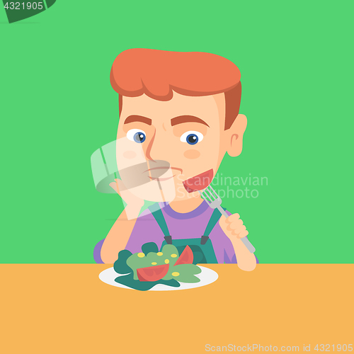 Image of Boy refusing to eat salad with healthy vegetables.