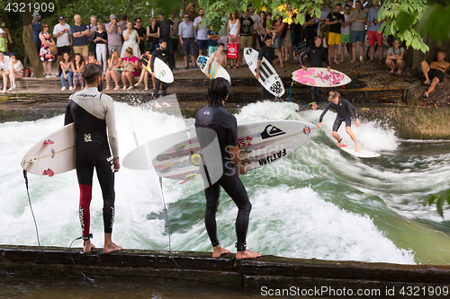 Image of Surfer surfing an artificial wave in Munich city center, Germany.