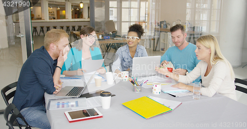 Image of Young people brainstorming in office