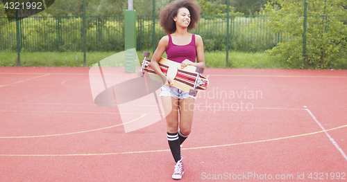 Image of Sportive woman with longboard