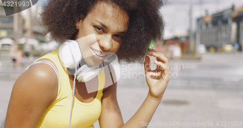 Image of Model in headphones at street 