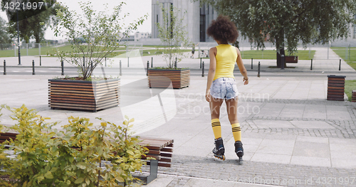 Image of Anonymous woman roller skating in park