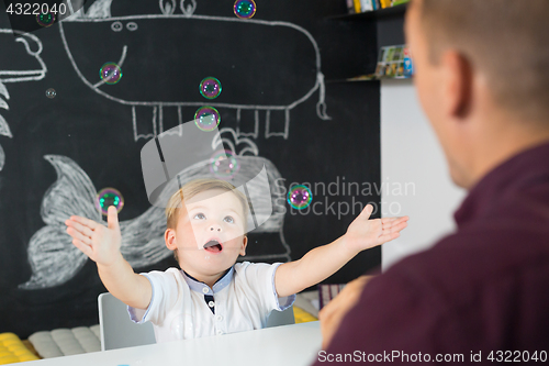 Image of Cute little toddler boy at child therapy session.