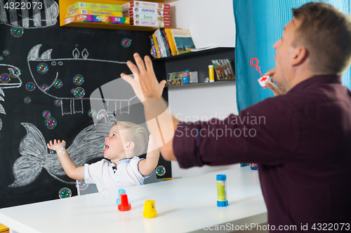 Image of Cute little toddler boy at speechtherapist session.